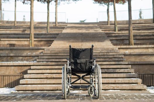 Wheelchair by the stairs without people outdoors