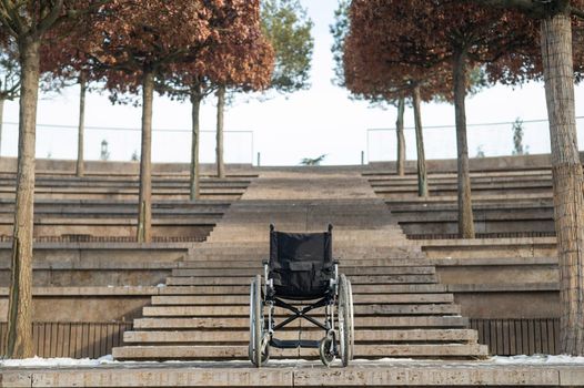 Wheelchair by the stairs without people outdoors