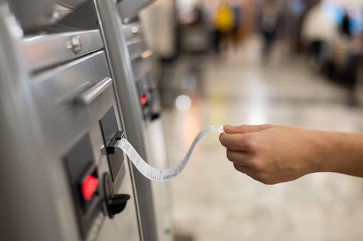 A woman takes a train ticket from a self-service ticket office