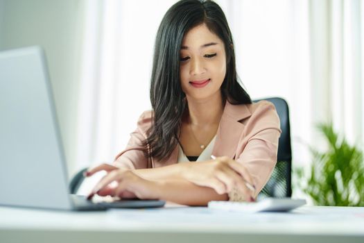 accountant, Auditor, Self-Employed, Finance and Investment, tax calculation and budget, Portrait of Asian female entrepreneur using a calculator to calculate. Company business results document