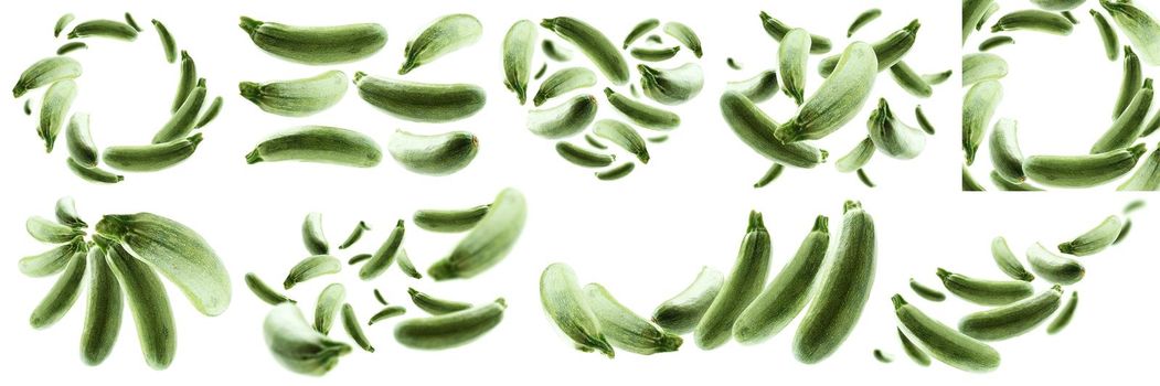 A set of photos. Green zucchini levitate on a white background.