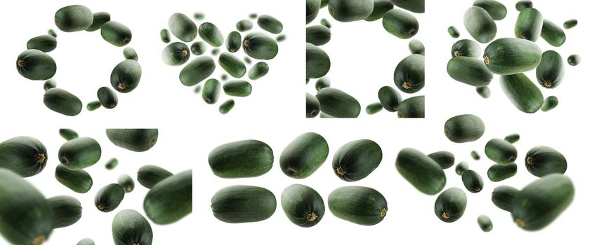 A set of photos. Green zucchini levitate on a white background.