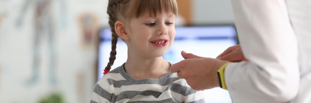 Little beautiful girl at doctor appointment. Pediatrician medical consultation concept