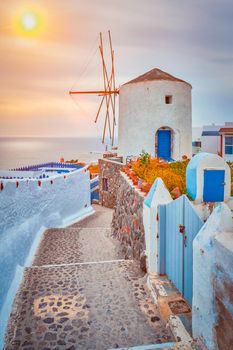 Old traditional whitewashed greek windmill on Santorini island in Oia town with stairs in street. Oia village, Santorini, Greece