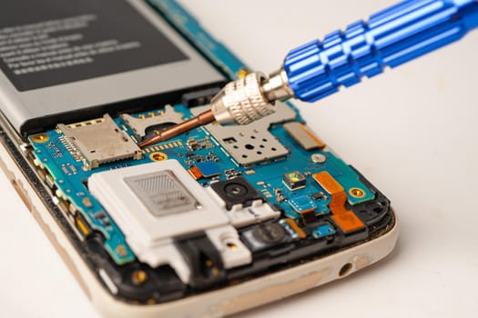 Technician repairing inside of mobile phone by soldering iron. Integrated Circuit. the concept of data, hardware, technology.