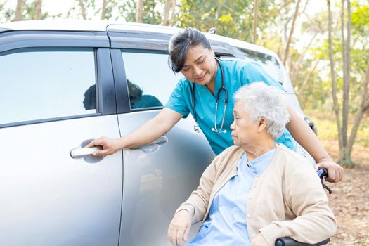 Help and support asian senior or elderly old lady woman patient sitting on wheelchair prepare get to her car, healthy strong medical concept.