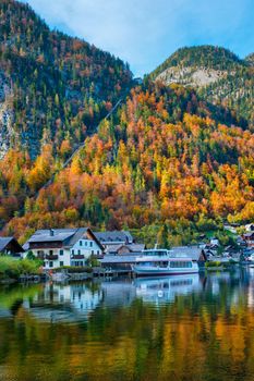 Austrian tourist destination Hallstatt village on Hallstatter See lake lake in Austrian alps with tourist boat. Salzkammergut region, Austria