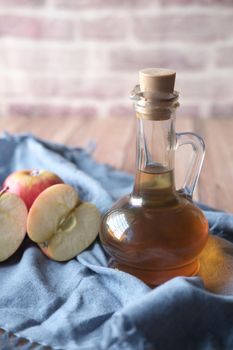 apple vinegar in glass bottle with fresh green apple on table ,