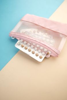 birth control pills on wooden background, close up .