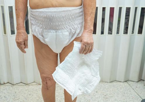 Asian senior or elderly old lady woman patient wearing incontinence diaper in nursing hospital ward, healthy strong medical concept.