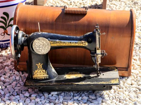 Guardamar, Alicante, Spain- April 3, 2022: Vintage sewing machine Singer brand for sale at the flea market called El Fogon in Guardamar, Alicante