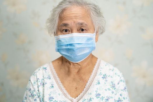 Asian senior or elderly old lady woman patient wearing a face mask for protect safety infection Coronavirus Covid-19 virus.