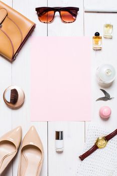 Flat lay, top view, mock up women's clothes and accessories on a white background. shoes, perfume, sunglasses