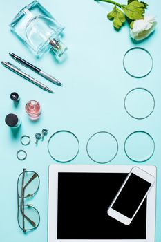 Flat lay, top view, mock up women's sexy clothes and accessories on a turquoise background. Phone, bracelet, perfume