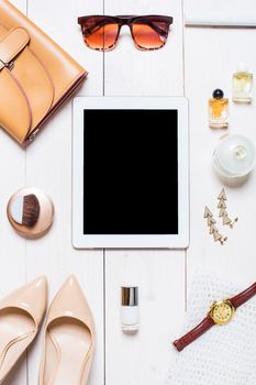 Flat lay, top view, mock up women's clothes and accessories on a white background. shoes, tablet, perfume, sunglasses