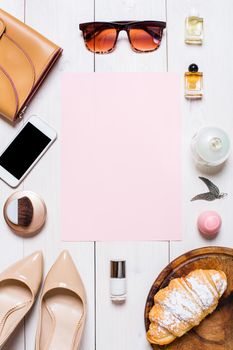 Flat lay, top view, mock up women's clothes and accessories on a white background. phone, shoes, perfume, sunglasses, croissant