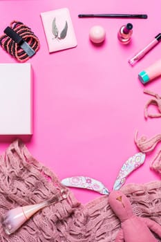 Flat lay, top view, mock up girl's accessories on a pink background. bracelet, rabbit, toy, perfume