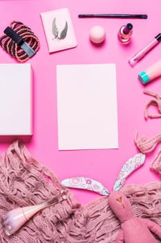 Flat lay, top view, mock up girl's accessories on a pink background. bracelet, rabbit, toy, perfume