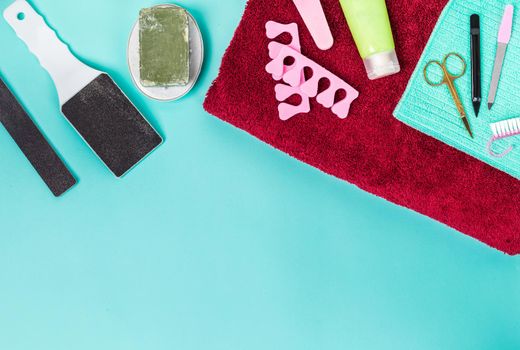 Top view of manicure and pedicure equipment on blue background. Still life. Copy space