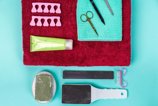 Top view of manicure and pedicure equipment on blue background. Still life.