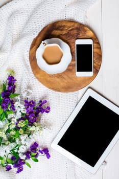 Flat lay, top view, mock up women's accessories on a white background. phone, tablet, a cup of coffee