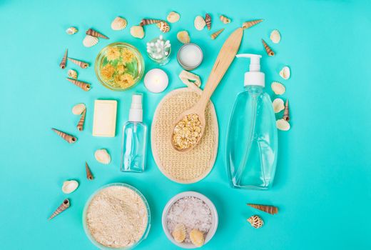 Natural domestic products for skincare on a blue background. Oat, oil, soap, facial cleanser. Top view. Still life. Copy space