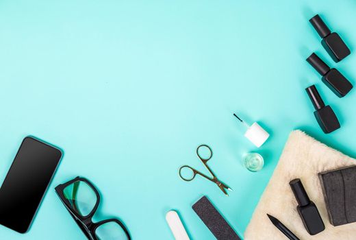 Top view of manicure and pedicure equipment on blue background. Still life. Copy space