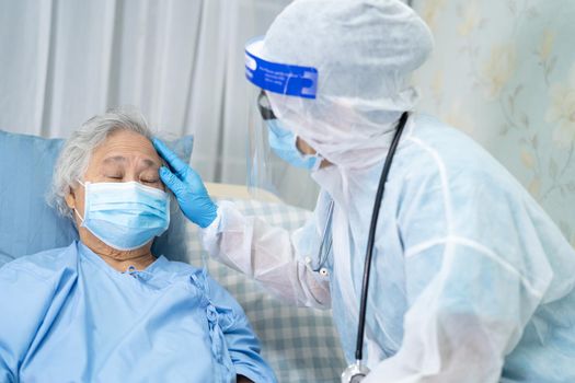 Asian doctor wearing face shield and PPE suit new normal to check patient protect safety infection Covid-19 Coronavirus outbreak at quarantine nursing hospital ward.