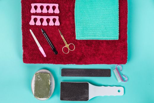 Top view of manicure and pedicure equipment on blue background. Still life.