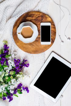 Flat lay, top view, mock up women's accessories on a white background. phone, tablet, a cup of coffee