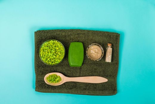 Spa set: soap, mask, oil, sea salt and towel. Top view Still life