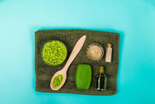 Spa set: soap, mask, oil, sea salt and towel. Top view Still life