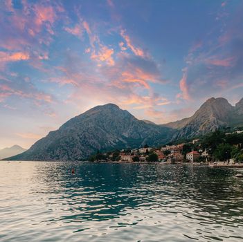 Sunset, beautiful landscape with silhouettes of trees. Travel concept. Montenegro, Kotor Bay. Sunset at Kotor Bay Montenegro. View of the sunset in Boko-Kotor Bay in Montenegro. Silhouettes of mountains. High quality photo