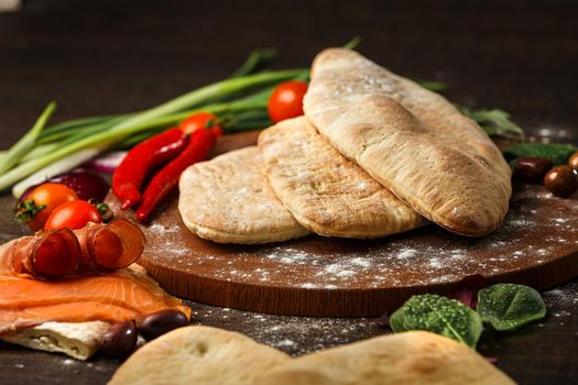 Doner kebab or pita on a wooden tray.