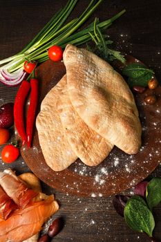 Doner kebab or pita on a wooden tray.