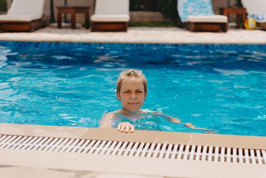 Happy child having fun on summer vacation. Kid playing with rubber duck and ball in the sea. Healthy lifestyle concept. Happy child playing in swimming pool. Summer vacations concept