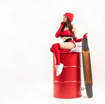 a girl in a red hat with a longboard in short red sports summer clothes