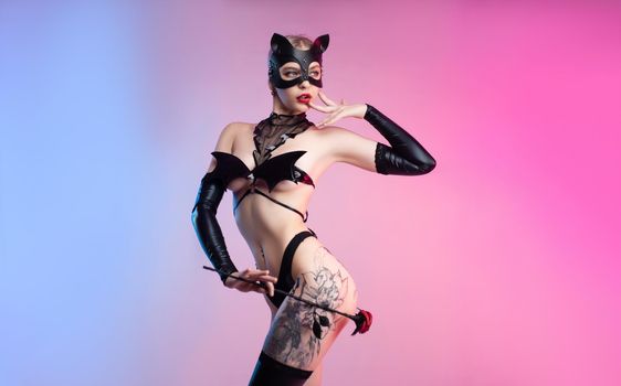 the sexy woman in a leather cat mask with a leather rose bdsm in underwear