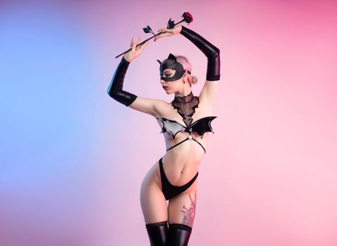 the sexy woman in a leather cat mask with a leather rose bdsm in underwear