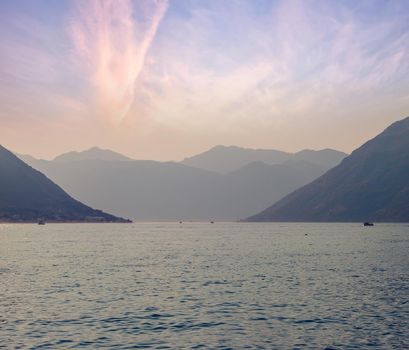 Sunset, beautiful landscape with silhouettes of trees. Travel concept. Montenegro, Kotor Bay. Sunset at Kotor Bay Montenegro. View of the sunset in Boko-Kotor Bay in Montenegro. Silhouettes of mountains. High quality photo