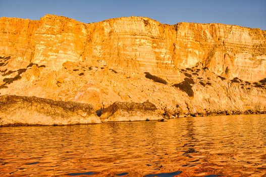 Coast of Crete island in Greece. Red Beach of famous Matala. Filtered retro toned style.