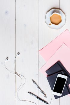 Flat lay, top view, mock up women's accessories on a white background. phone, pen, paper, a cup of coffee, notebook