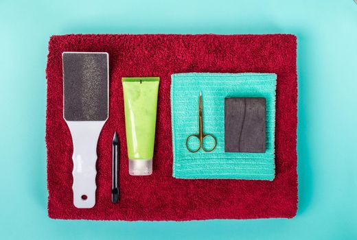 Top view of manicure and pedicure equipment on blue background. Still life.