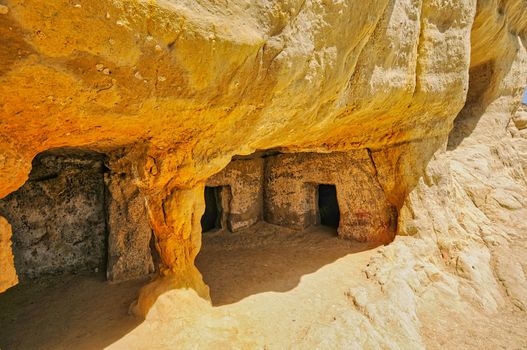 Matala beach with caves on the rocks that were used as a roman cemetery and at the decade of 70's