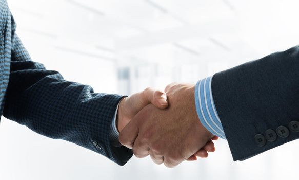 A close-up of a handshake. Making a deal between two businessmen