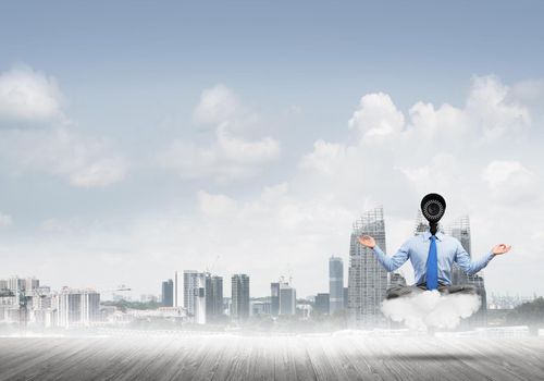 Elegant businessman outdoors floating on cloud and camera instead of head