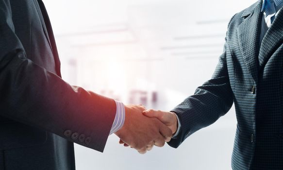 A close-up of a handshake. Making a deal between two businessmen