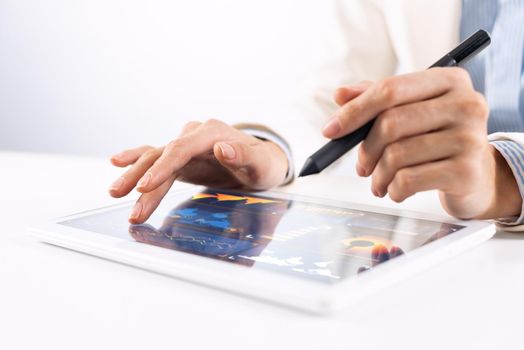 Man in white business suit using tablet computer. Close-up of male hands holding pen and tablet gadget. Mobile smart device in business occupation. Online services of business analytics for trading