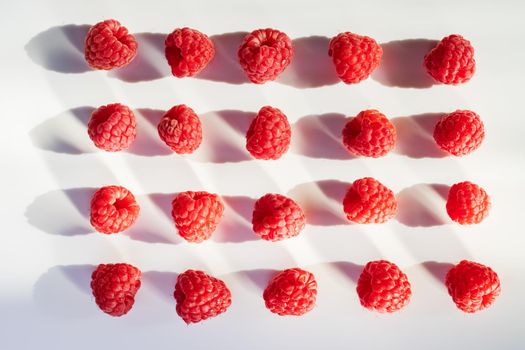 raspberries lie on a white background, tasty food