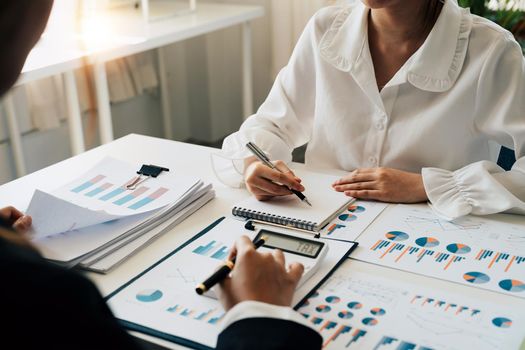 Financial adviser working with client, calculating and analyzing data paperwork chart for meeting team in office room. concept finance and accounting.